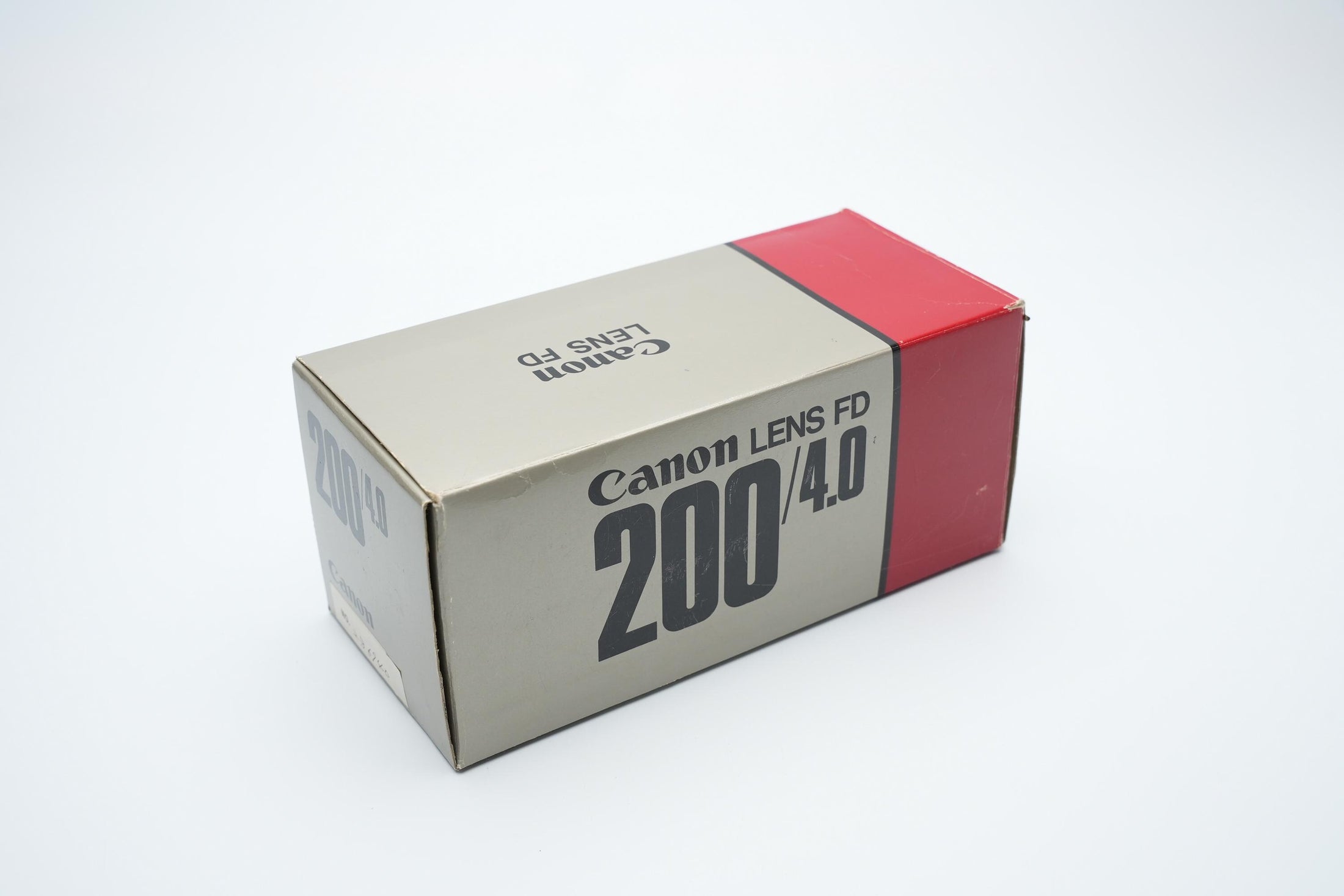 Canon FD 200mm f/4 S.S.C. Telelens - Iconische Optiek met Reinigingspotentieel