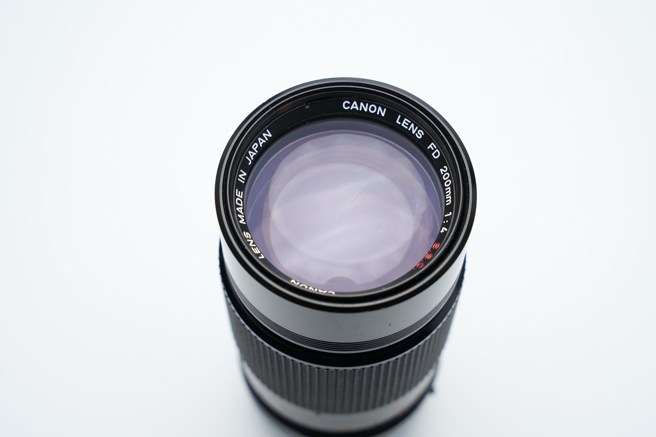 Canon FD 200mm f/4 S.S.C. Telelens - Iconische Optiek met Reinigingspotentieel