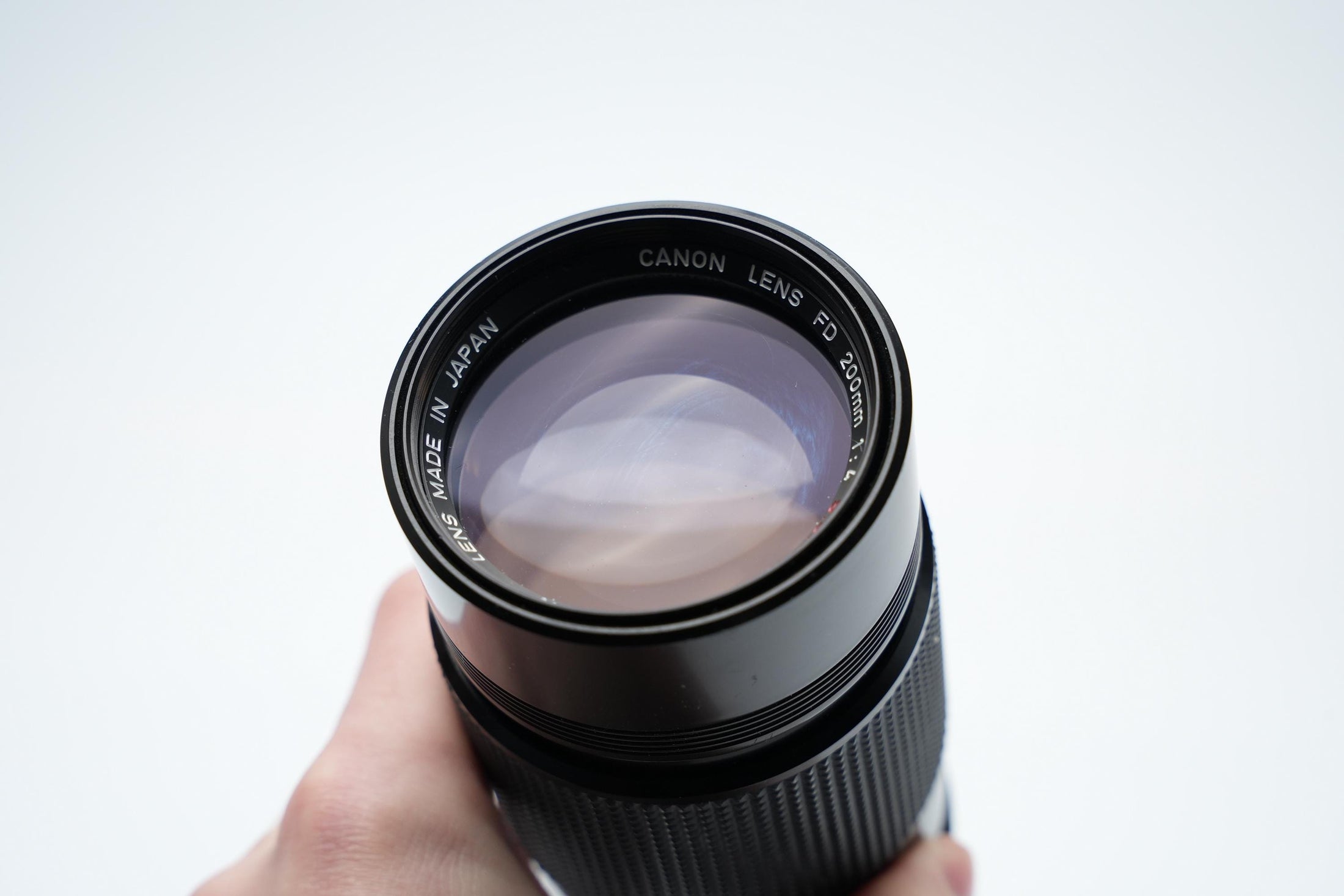 Canon FD 200mm f/4 S.S.C. Telelens - Iconische Optiek met Reinigingspotentieel